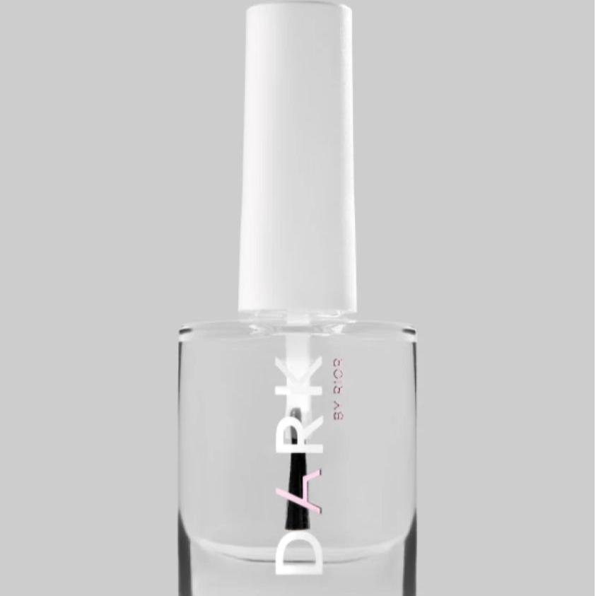 Clear nail polish bottle with white cap on grey background, professional manicure supply