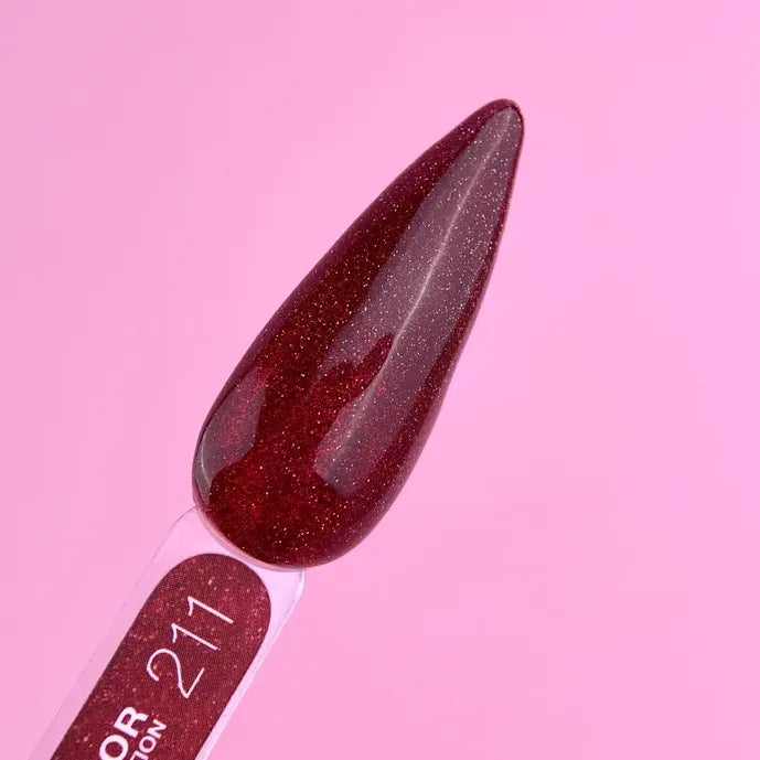 Dark red glitter gel nail polish swatch on plastic stick with pink background