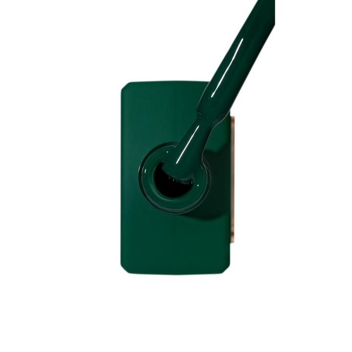 Green gel nail polish bottle with brush applicator, manicure product close-up