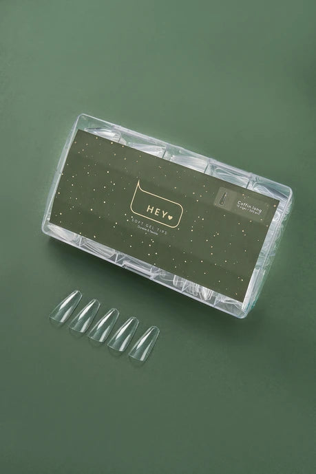 Nail art kit with clear nail tips and a branded case HEYLOVEon a green background