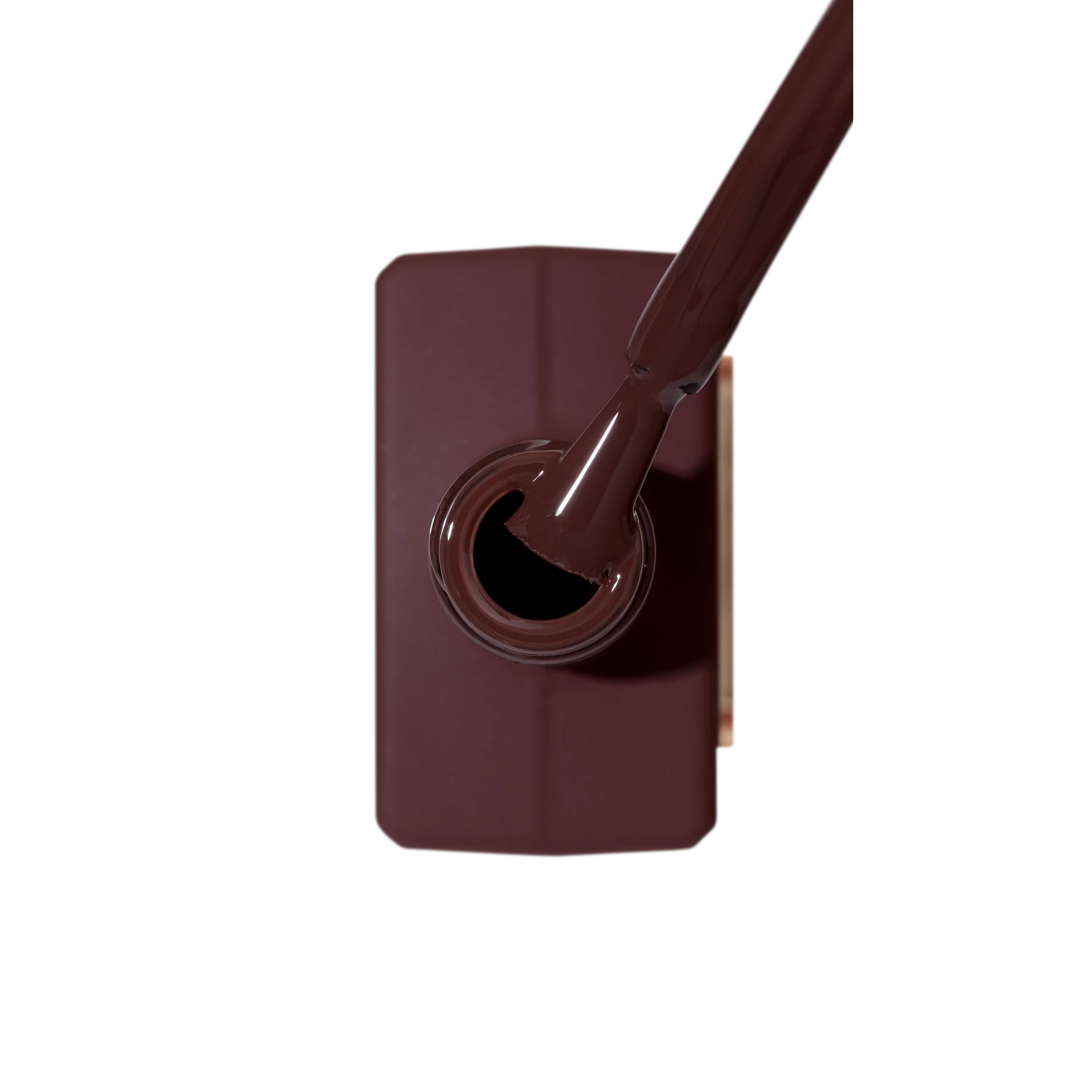 Top view of open brown gel nail polish bottle with brush for manicure