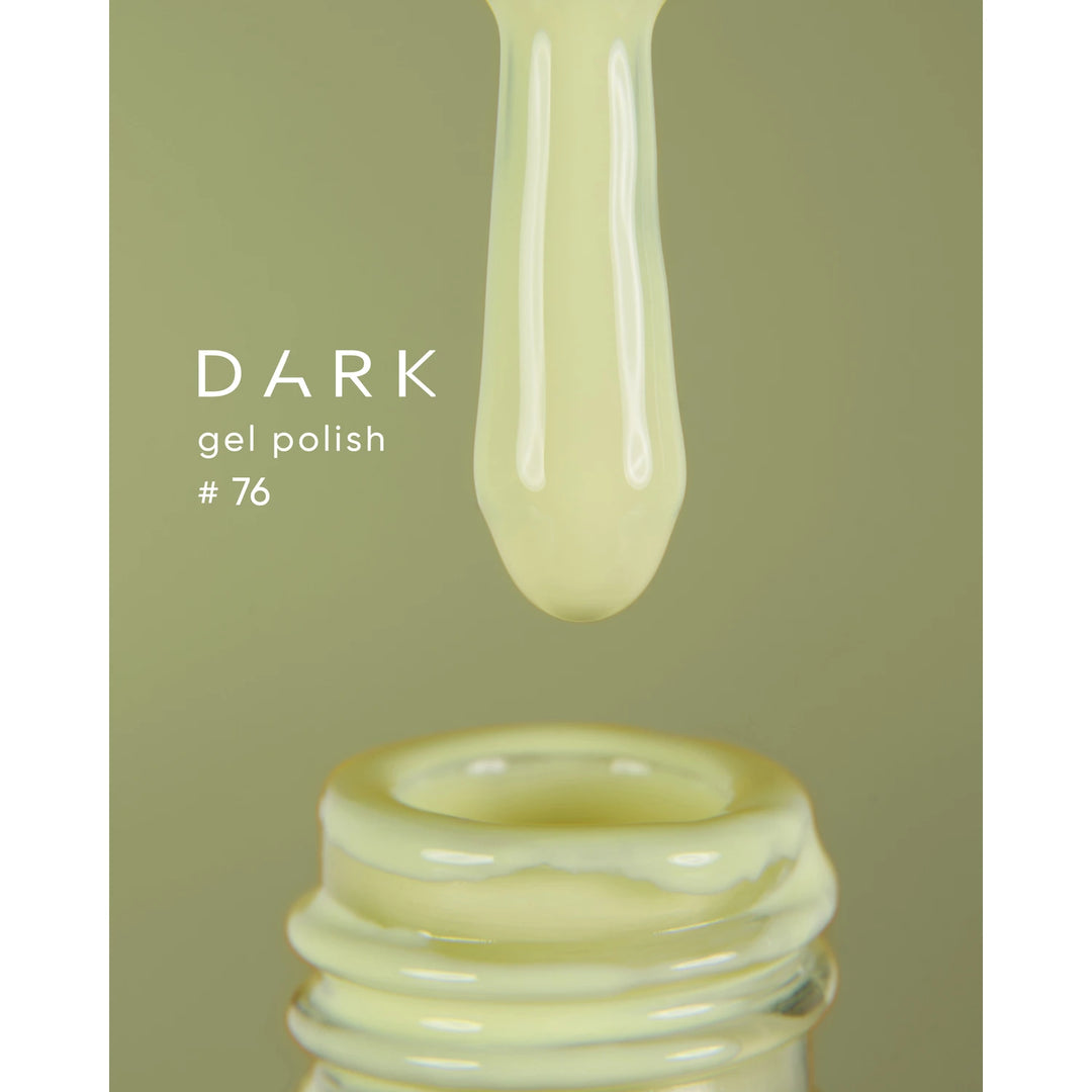 Pale yellow gel polish number 76 dripping from brush into open nail polish bottle