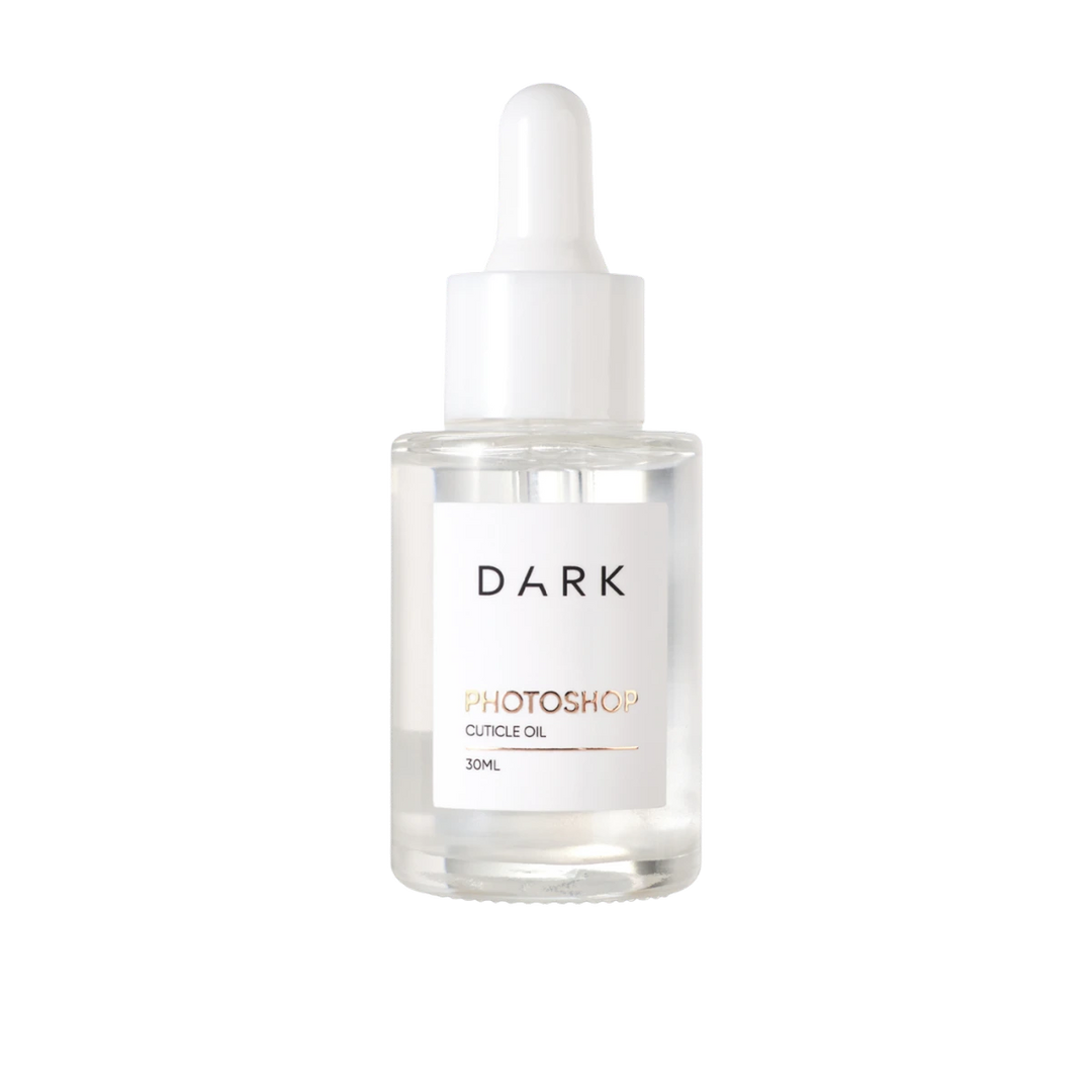 A 30ml glass dropper bottle of DARK Photoshop Cuticle Oil with a white label and white dropper cap, shown on a solid white background.