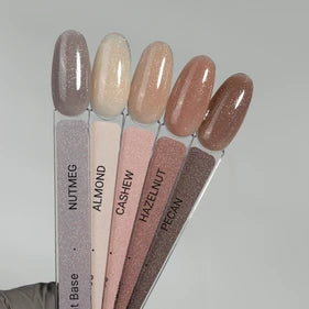 Set of five neutral gel nail polish swatches labeled Nutmeg, Almond, Cashew, Hazelnut, Pecan