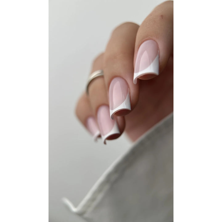 Hand with pink and white French tip manicure, glossy UV gel nails, professional nail art