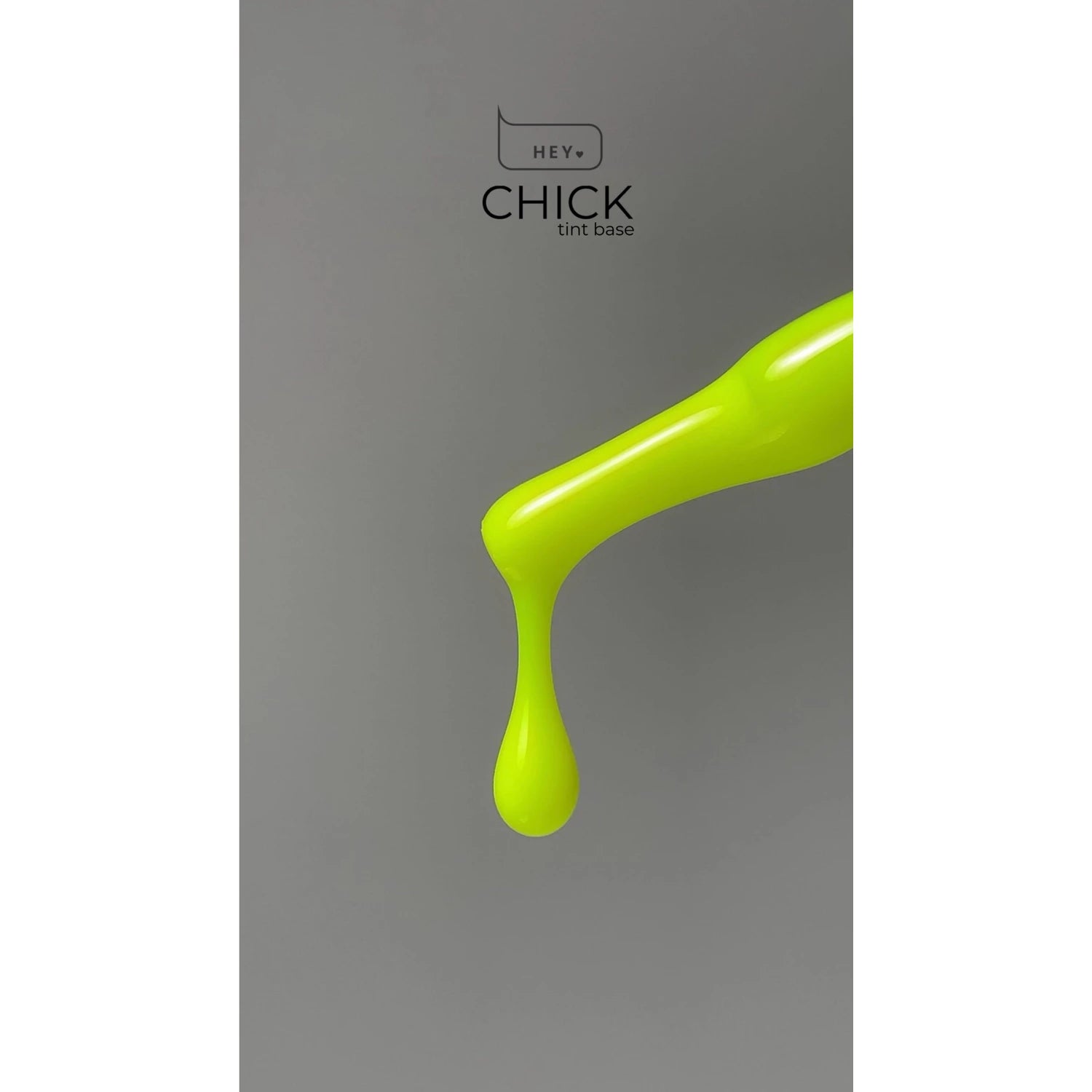 Neon yellow nail gel polish drop on brush with 'HEY CHICK tint base' text on grey background.