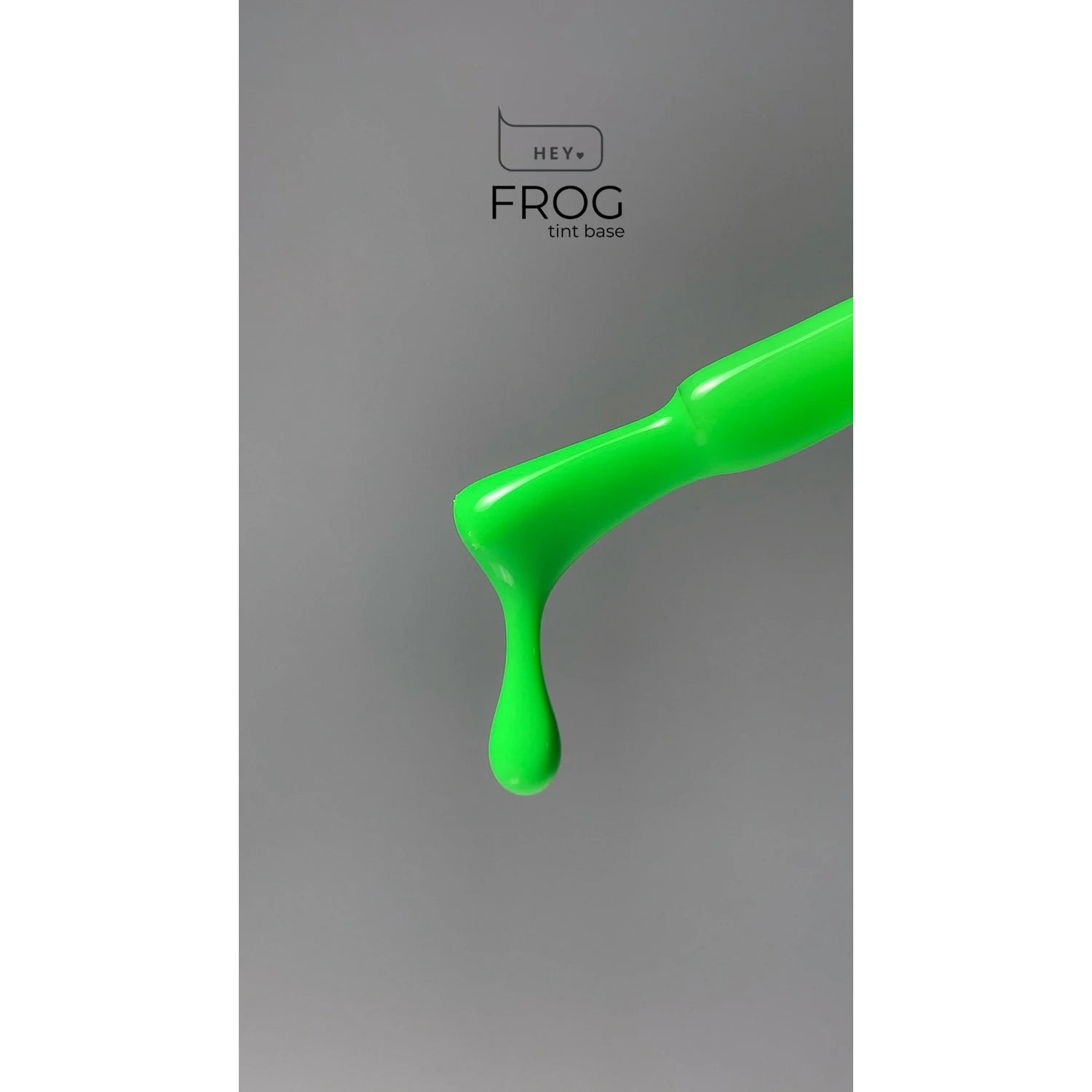 Bright green gel nail polish drop on brush, labeled HEY FROG tint base, grey background