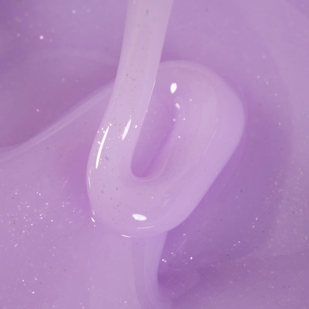 Close-up of glossy lavender UV gel nail polish with subtle glitter texture.