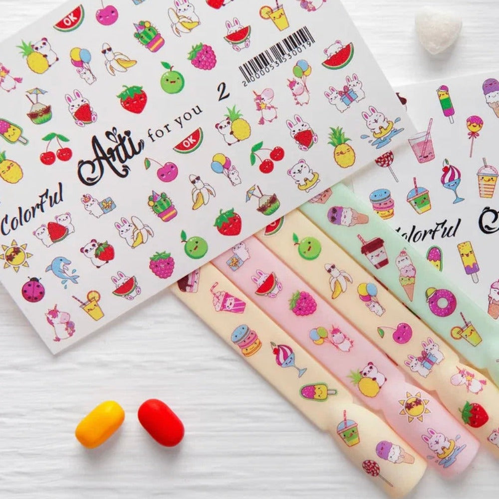 Colorful nail art stickers with cute fruit and animal designs on a white background