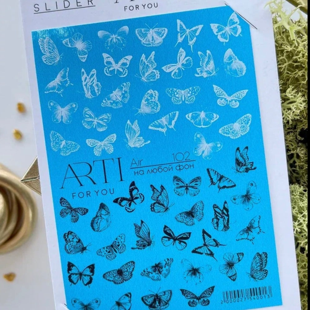 Butterfly nail art stickers sheet for manicures, featuring white and black butterfly designs