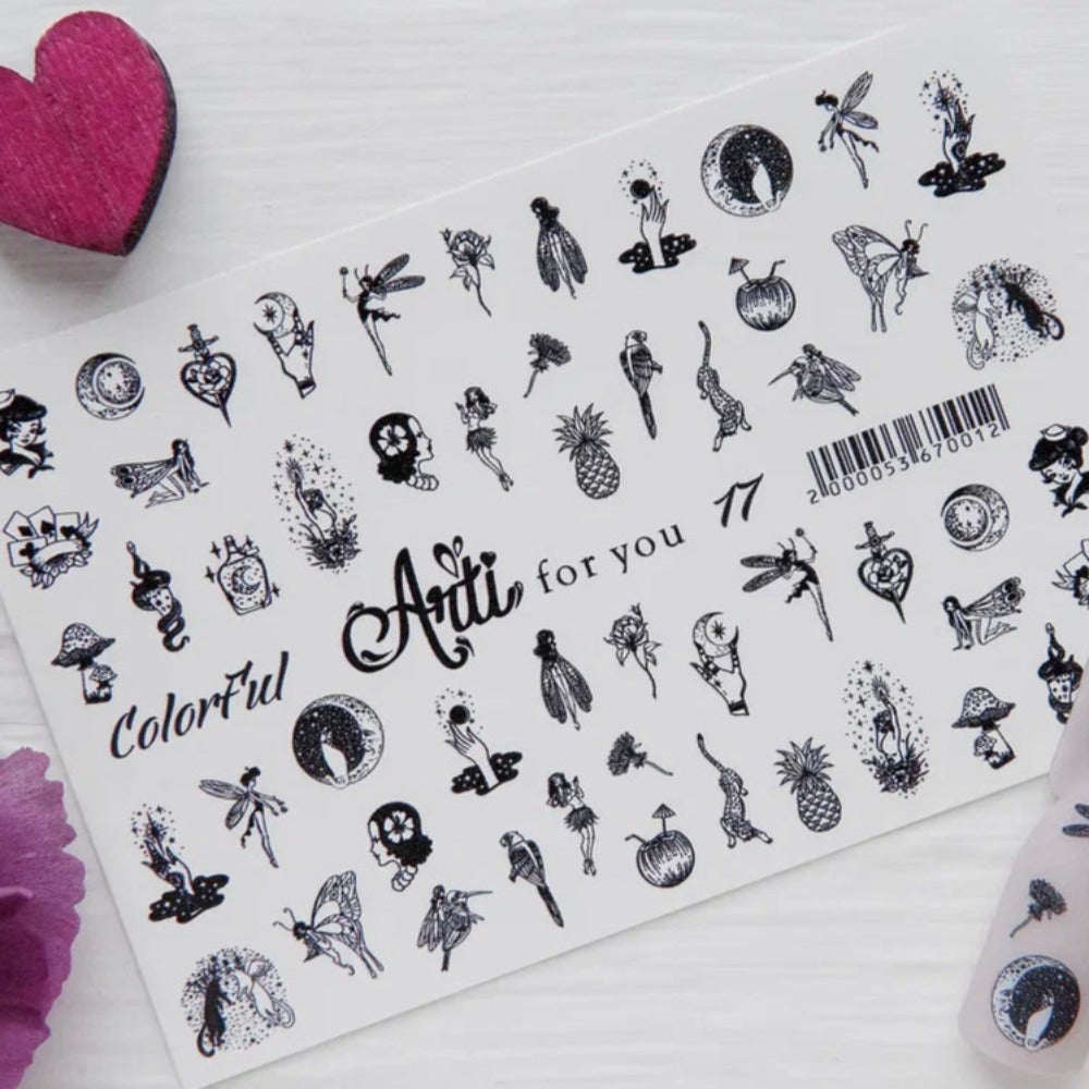 Sheet of black and white nail art stickers with fairy and nature designs on a white background
