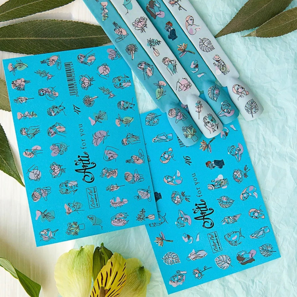 Blue nail art sticker sheets with minimalist face and flower designs, shown with decorated nail tips