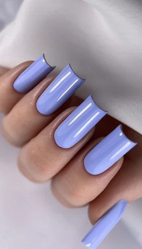 Hand with long coffin-shaped nails painted glossy pastel lavender, manicure closeup
