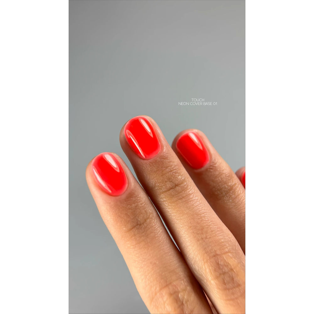 Hand with short nails painted neon red, glossy UV gel polish manicure