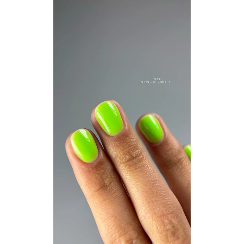 Hand with glossy neon green gel polish manicure on short nails