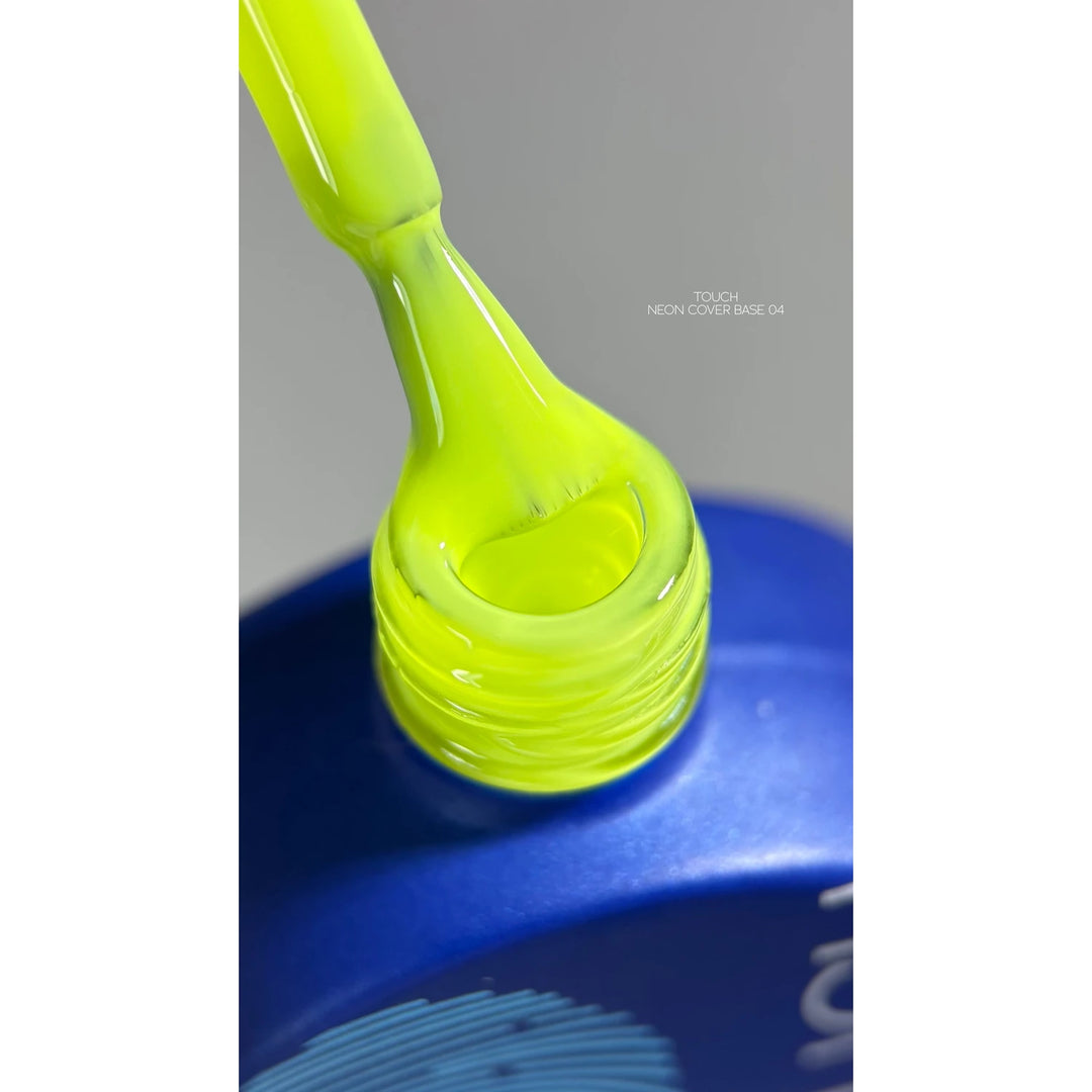Neon yellow UV gel polish brush over blue bottle for manicure and nail art