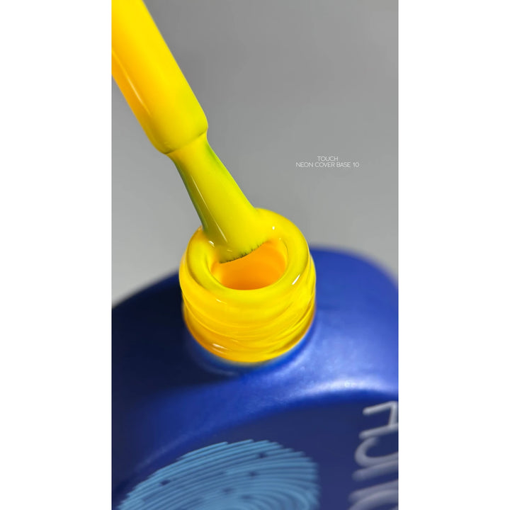 Yellow neon nail polish brush above open bottle, nail art manicure supplies
