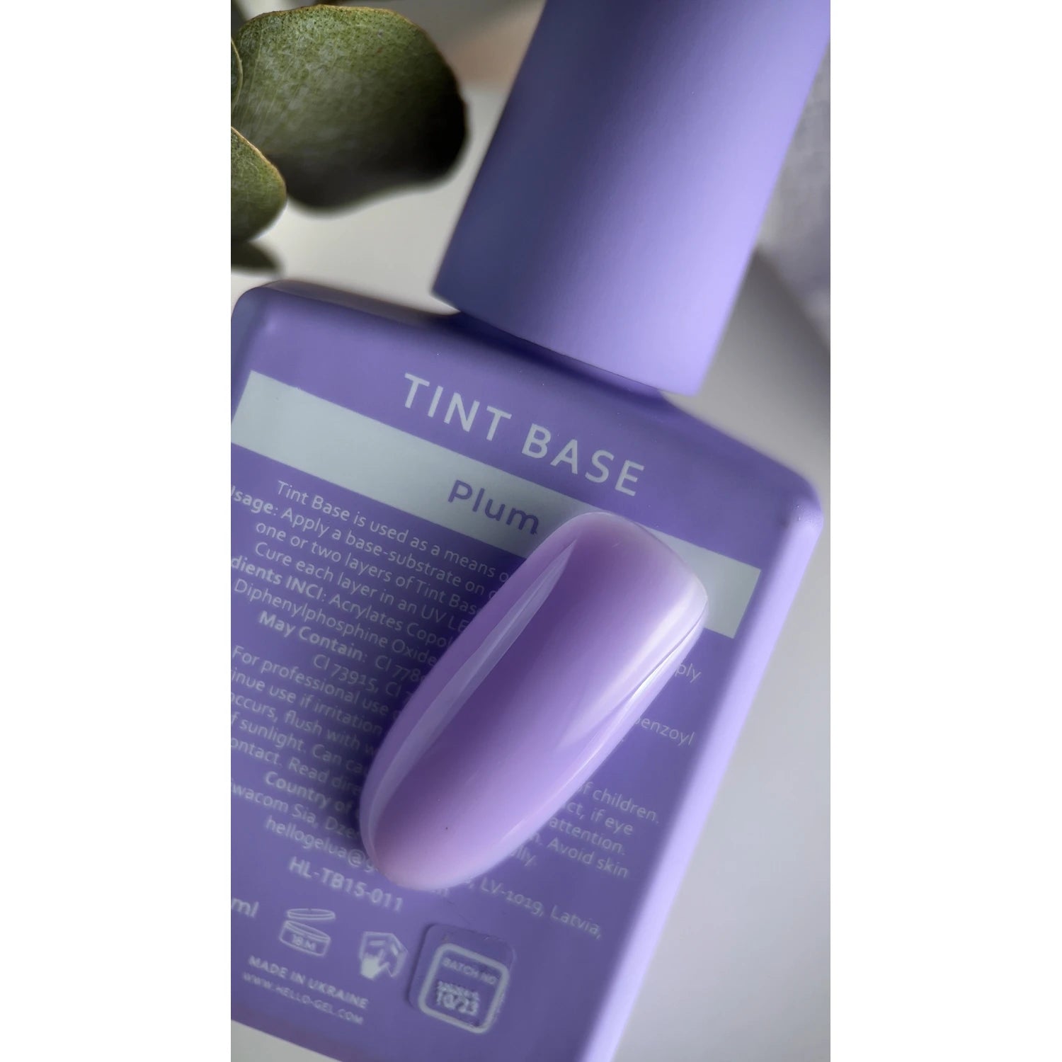 Plum tinted nail gel polish bottle with matching purple nail swatch