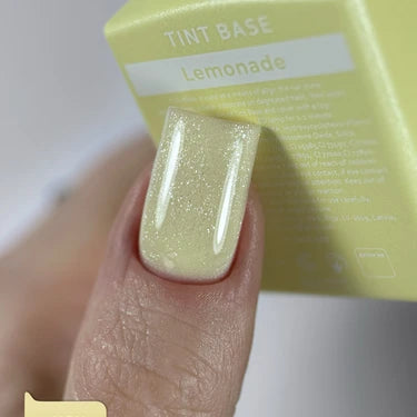 Shimmery pastel yellow gel nail polish on a manicured fingernail, tint base Lemonade