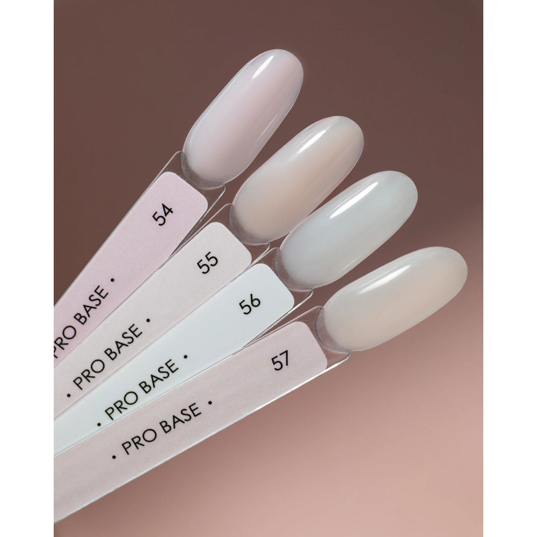 Set of pale nude gel nail polish color samples labeled Pro Base 54 to 57 on display sticks