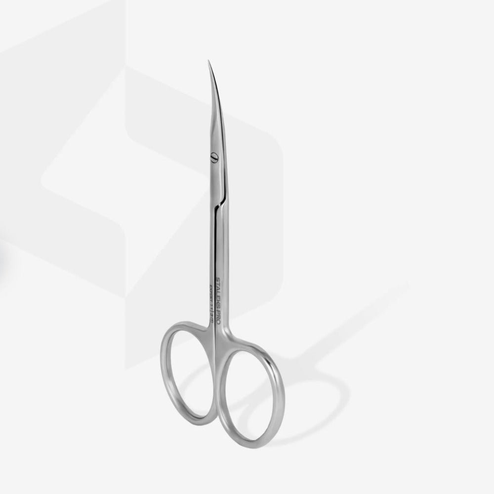 Stainless steel curved manicure scissors for nail and cuticle care on white background