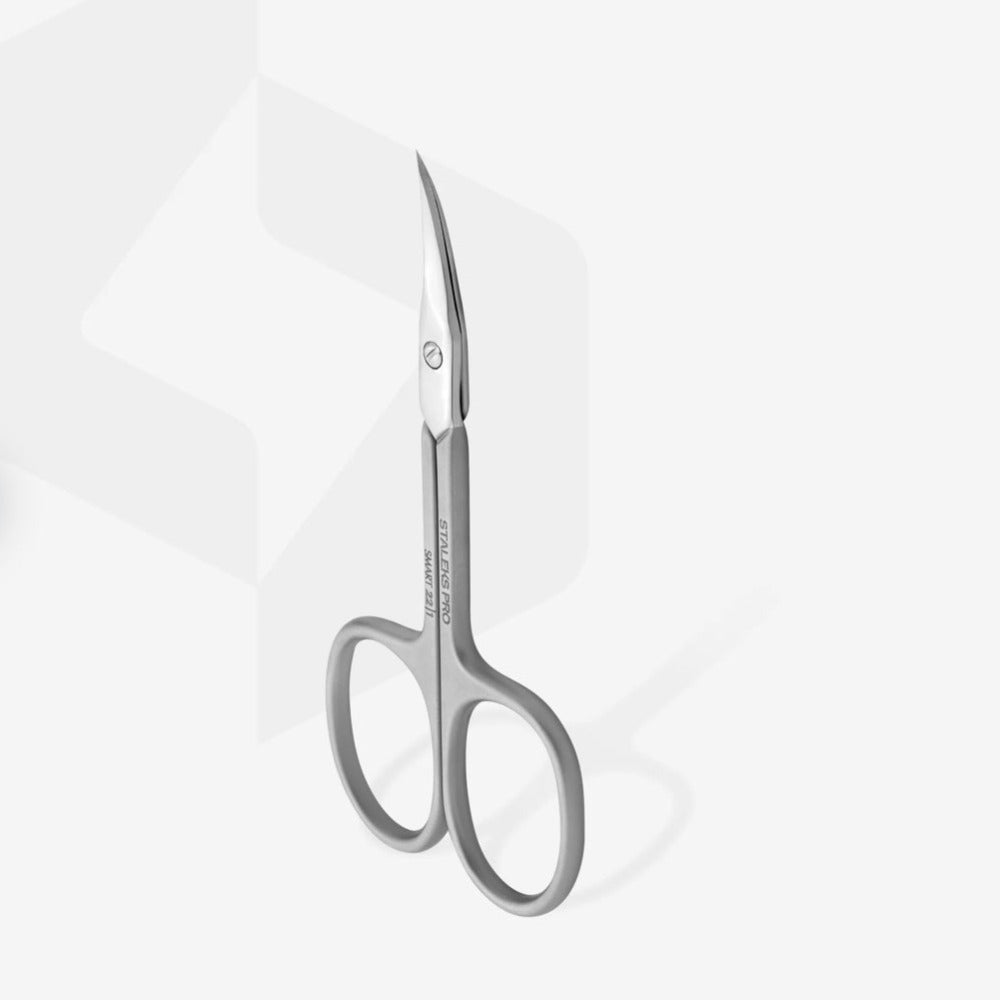 Curved stainless steel manicure scissors for nail and cuticle care on white background