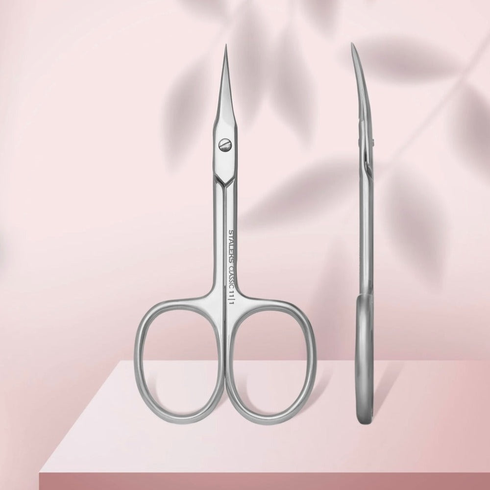 Stainless steel cuticle scissors for manicure, straight sharp blades, on soft pink background