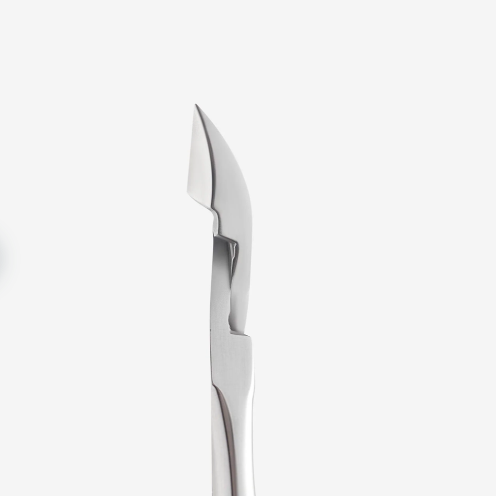 Stainless steel cuticle pusher manicure tool with angled edge on white background