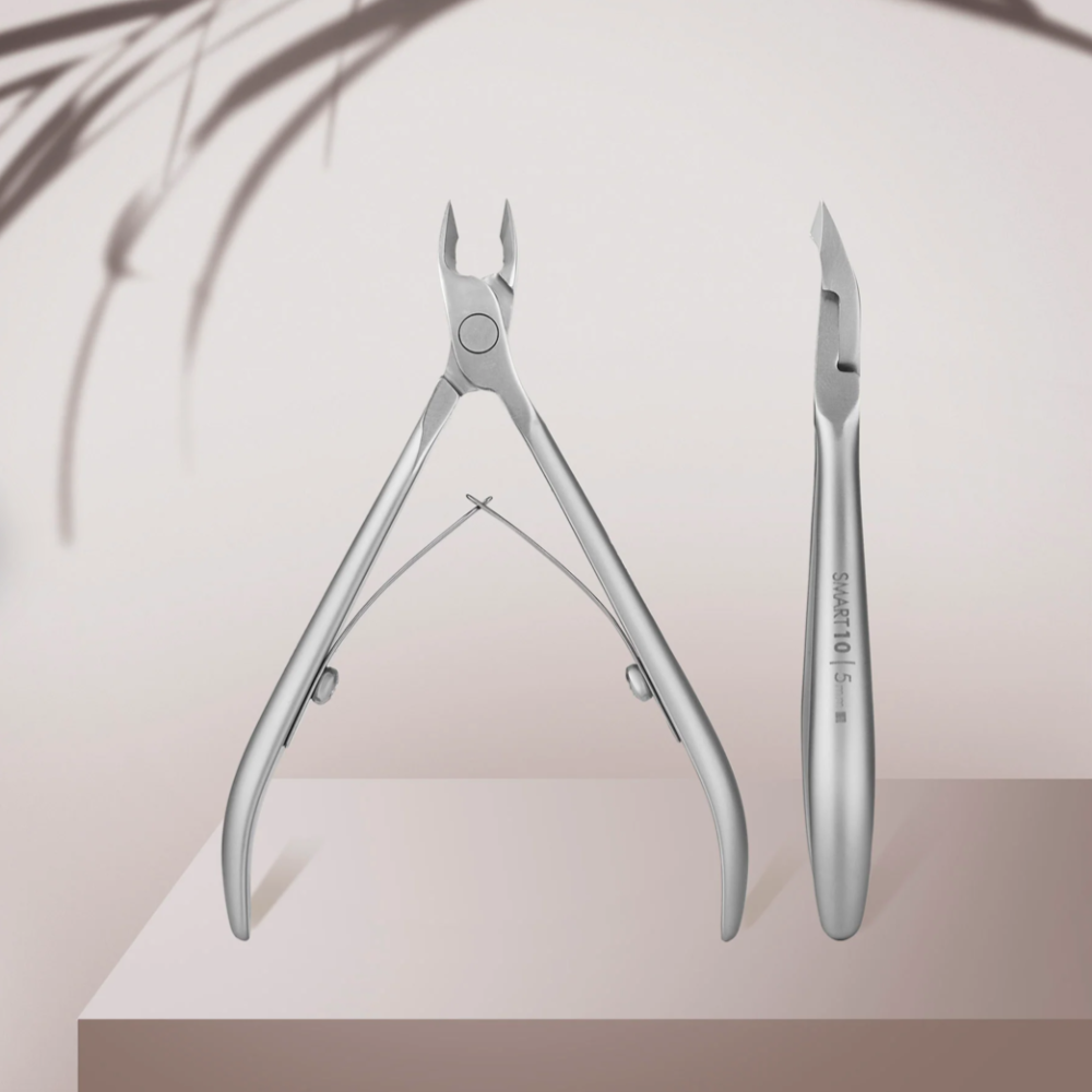 Stainless steel cuticle nippers for manicure and pedicure on a neutral background