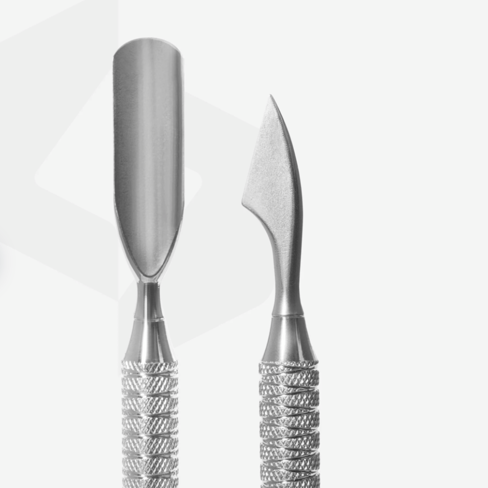 Stainless steel nail cuticle pusher and gel remover manicure tools on white background