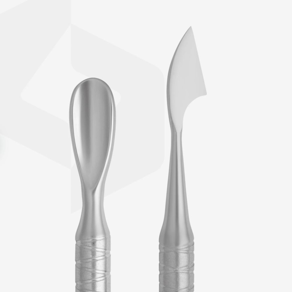 Stainless steel manicure cuticle pusher and nail cleaner on white background