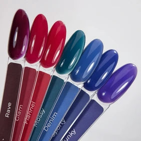 Set of six nail polish color samples in red, teal, blue, and purple shades for manicure