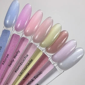 Assorted pastel UV gel nail polish swatches for manicures on clear sticks