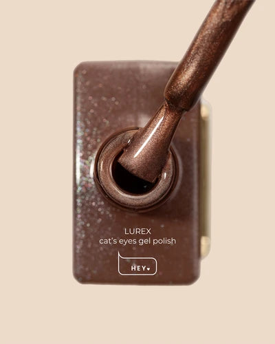 Brown shimmering cat's eyes gel nail polish with brush, labeled Lurex, for manicure