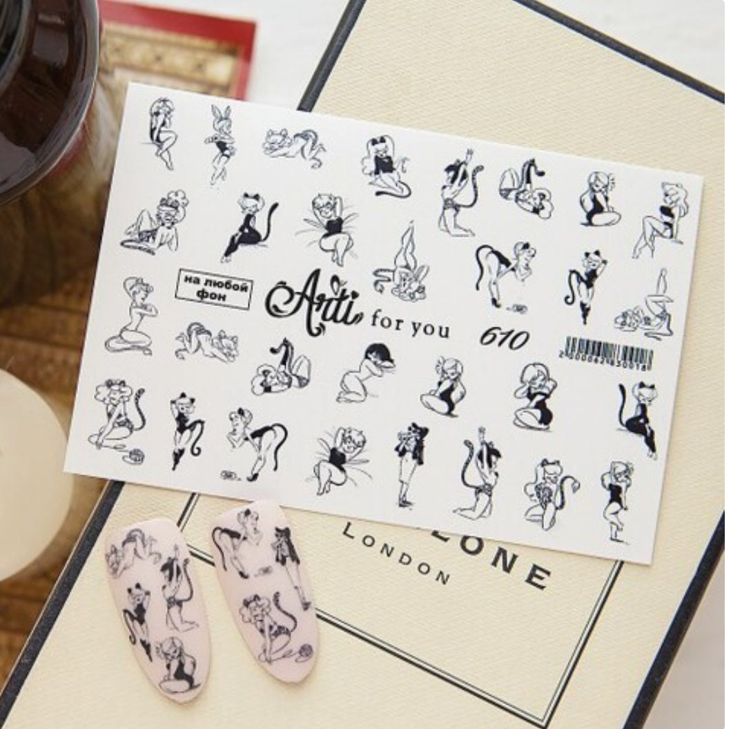 Sheet of black and white cartoon cat nail art stickers with two decorated nail tips