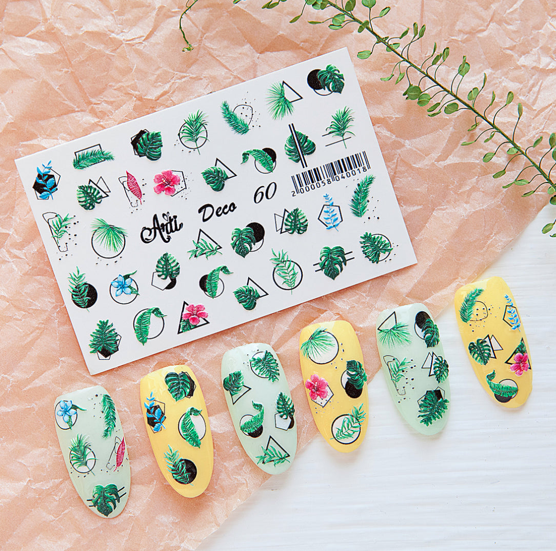 Tropical leaf and flower nail art stickers with sample decorated nails on pastel background