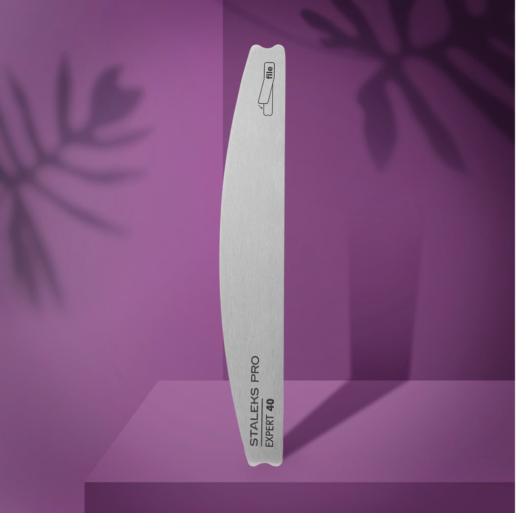 Stainless steel nail file Staleks Pro Expert 40 on purple background, professional manicure tool