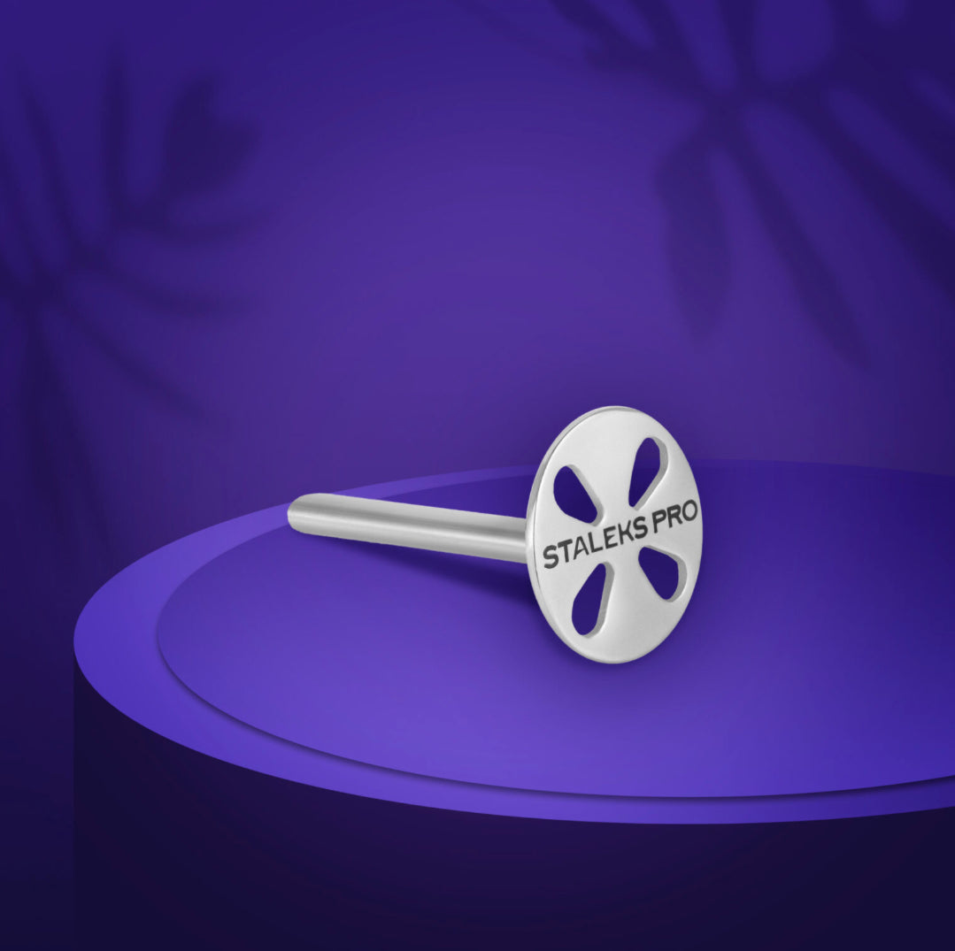 Metal nail drill bit with STALEKS PRO logo on a purple background, manicure tool