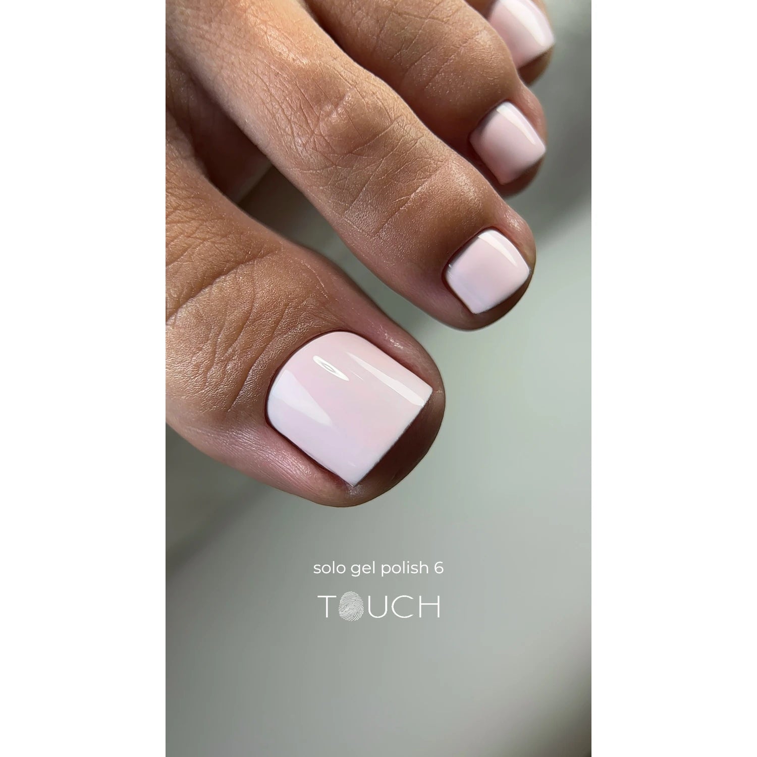 Close-up of toes with glossy light pink gel polish pedicure, text 'solo gel polish 6 TOUCH'.