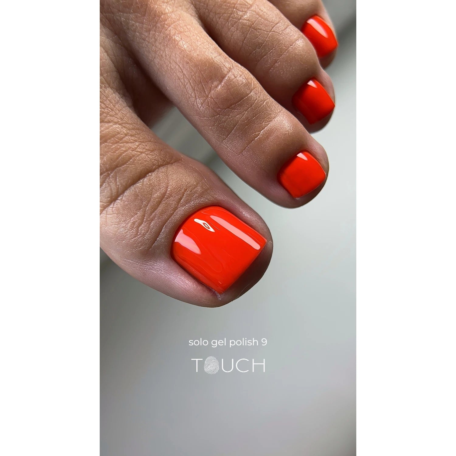 Close-up of toenails with glossy orange gel polish manicure, professional pedicure product.