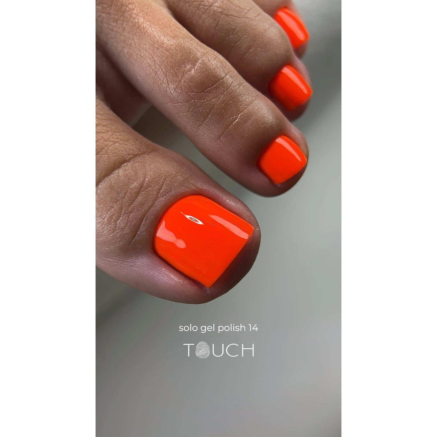 Bright orange gel polish pedicure on toenails, labeled solo gel polish 14 TOUCH.