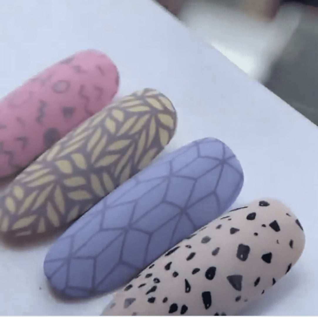Colorful press-on nails with geometric and abstract nail art designs