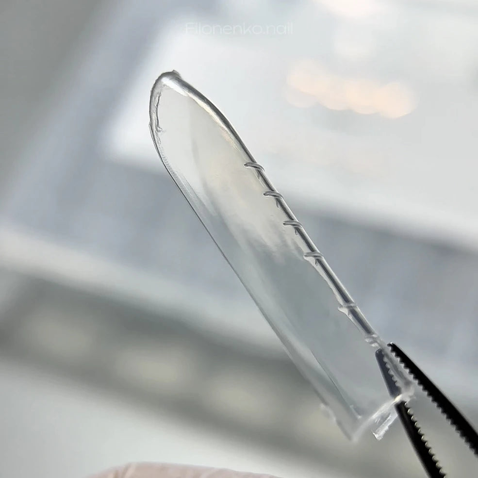 DARK Upper Forms Universal – transparent dual form with length markings held in tweezers