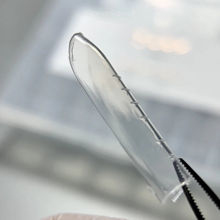 DARK Upper Forms Universal – transparent dual form with length markings held in tweezers