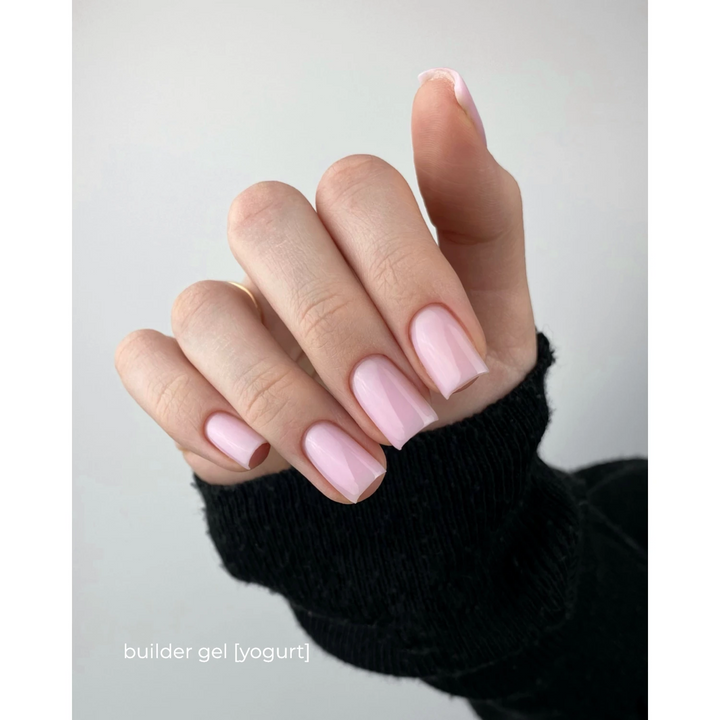 Hand with square-shaped nails featuring light pink builder gel manicure