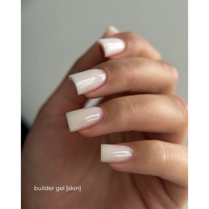 Hand with natural-looking square nude nails, glossy finish, builder gel manicure