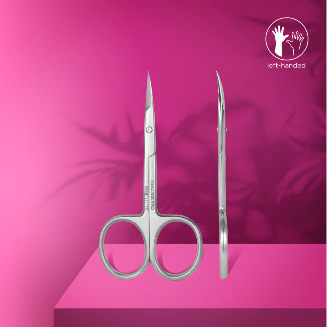 Left-handed stainless steel manicure scissors on a pink background, nail tool