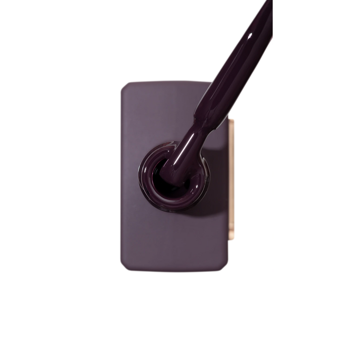 Dark purple gel nail polish bottle with brush, professional manicure product