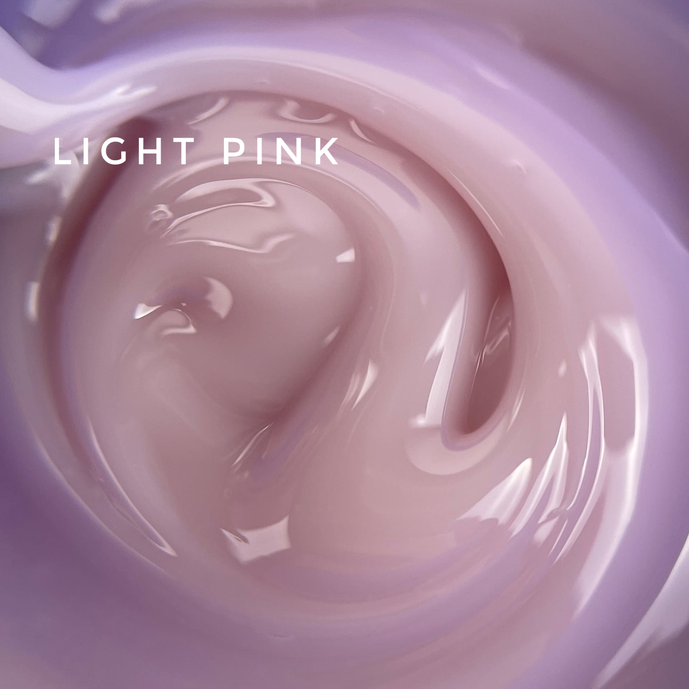Swirl of glossy light pink UV nail gel, creamy manicure product texture close-up
