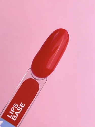 Red gel nail polish sample swatch labeled 'Lips Base' on a pink background